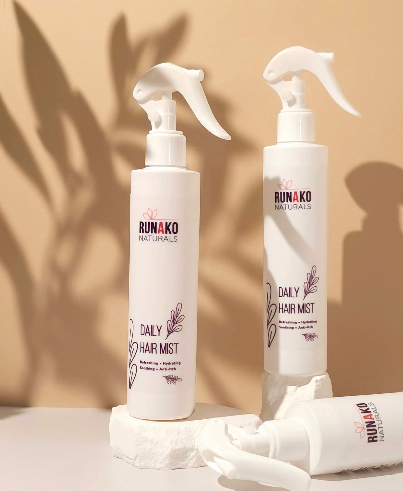 Runako Naturals daily hair mist bottles