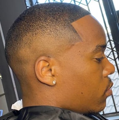 Close side profile of a taper fade with clean line-up