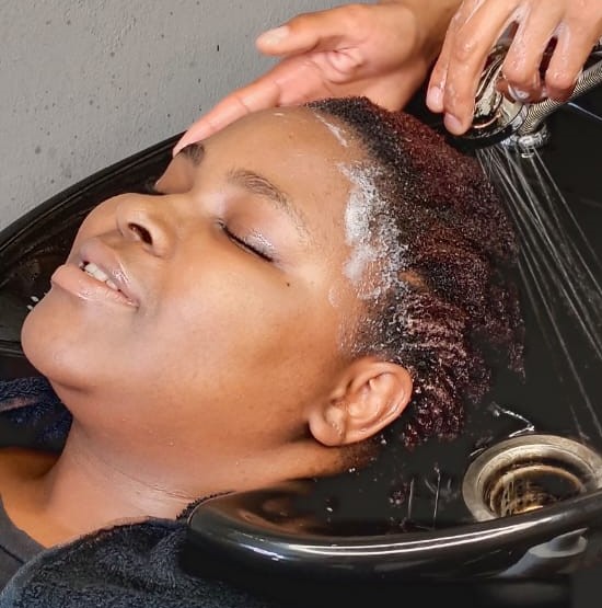 Client enjoying a salon wash service